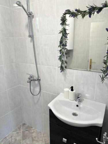 a white bathroom with a sink and a shower at Villa Sea House in Byala