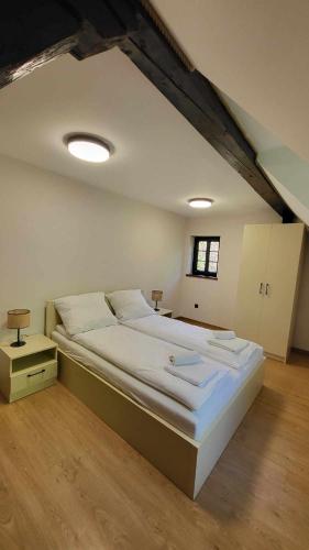 a bedroom with a large bed in a attic at Domek Zacisze Energylandia Zator Graboszyce in Graboszyce
