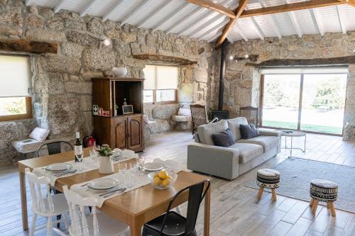 a living room with a table and a couch at Casas da Morgadinha - Arais Turismo Rural in Celorico de Basto