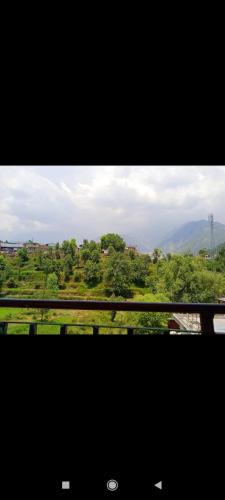 a view of a field from a train window at Anchal House in Dharamshala