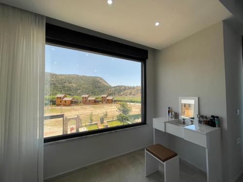 a bathroom with a large window with a view at Villalakehouse in Dalaman