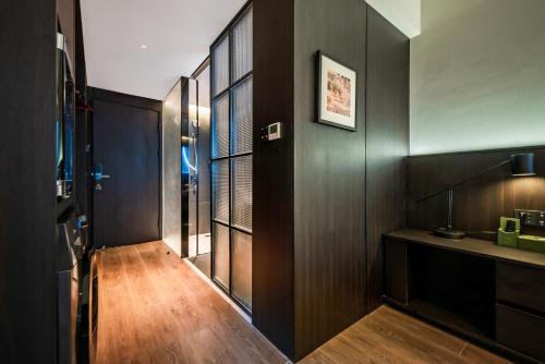 a hallway with dark wood paneling and a room with a door at Xi'an Firefly Hotel in Xi'an