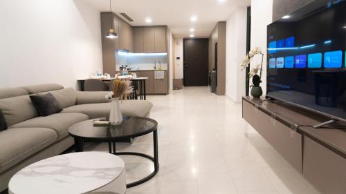 a living room with a couch and a tv at MOONWAY SUITES At EATON KLCC in Kuala Lumpur
