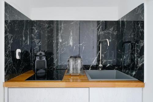 a kitchen counter top with a sink and a sink at Kefi Luxury Villas in Limenas