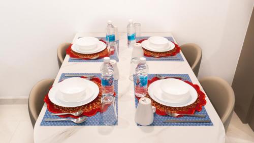 a table with two plates and water bottles on it at MOONWAY SUITES At EATON KLCC in Kuala Lumpur