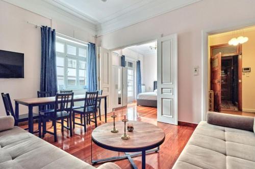 a living room with a couch and a table at Elegant apartment in Syntagma square in Athens