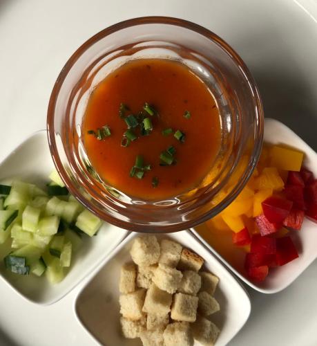 a plate of food with a bowl of soup and vegetables at Das Halali - dein kleines Hotel an der Zugspitze in Ehrwald