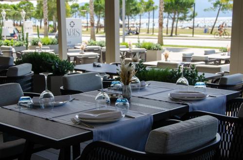 a table in a restaurant with blue tables and chairs at Abi's Hotel & SPA Vlore in Vlorë