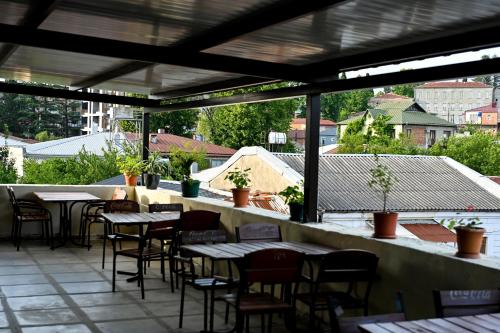a patio at a restaurant with tables and chairs at StarHostel in Kutaisi