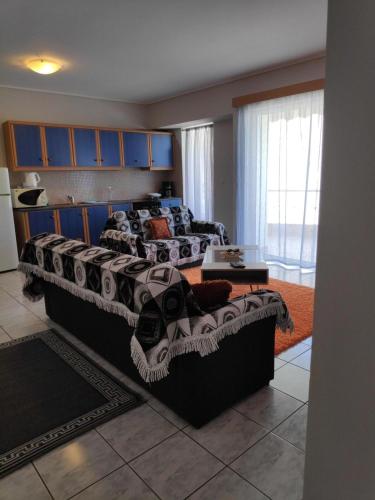 a bedroom with a large bed in a room at Daphnus Apartment in Agios Konstantinos in Agios Konstantinos Fthiotida