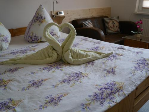 a swan made out of towels on a bed at Weidenhof Zinnowitz in Zinnowitz
