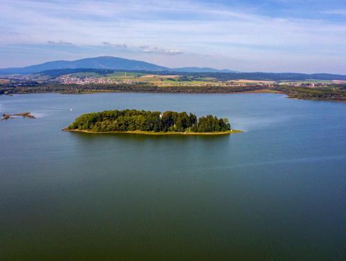 an island in the middle of a large body of water at Rezort pod Roháčmi in Vitanová