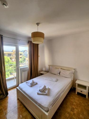 a bedroom with a bed with two towels on it at Vilele Liliana in Mamaia Sat/Năvodari