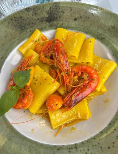 a plate of food with shrimp and other foods at Mare & Monti Casa Vacanze in Teulada