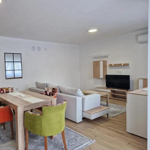 a living room with a couch and a table at Apartman Milos - centar grada free parking in Vranje