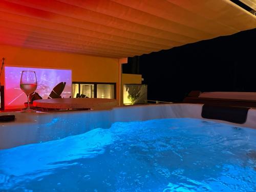 a hot tub with a glass of wine in a room at Private 250sqm Garden Duplex, Jacuzzi, Cinema, Sea View Escape in Torremolinos
