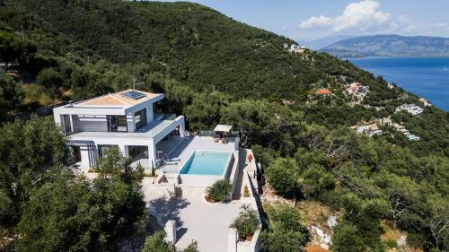an aerial view of a house with a swimming pool at Isle of Olive in Katávolos