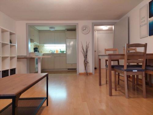 a living room with a table and a kitchen at Global Citizen 7 in St. Gallen