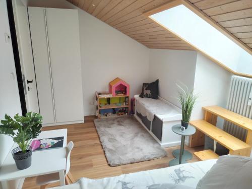 a small living room with a bed and a table at Almchalet mit Pool und Sauna in Missen-Wilhams