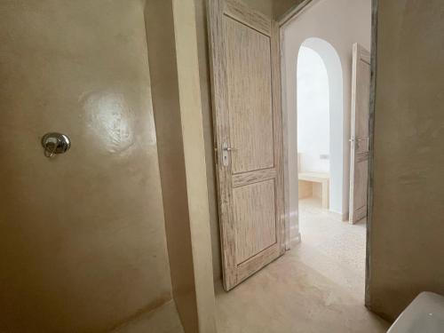 an empty hallway with an open door in a room at Airamjudi in Watamu