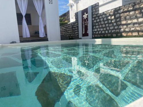 a swimming pool with at Airamjudi in Watamu