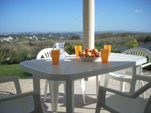 a white table with a bowl of fruit on it at Luxury 6 Bedroom Oceanfront Vila - Sleeps 22 Guests in Foz do Arelho