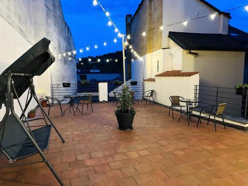 a patio with chairs and tables and lights at Small Luxury Palace Residence in Prague