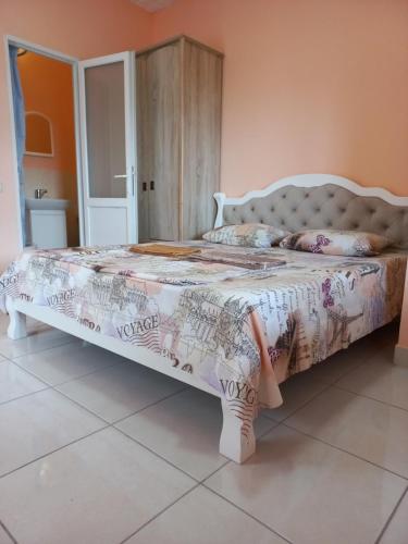 a bedroom with a large bed with a white bedspread at Black Sea STAR in Chornomorsk