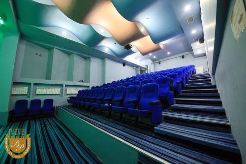 a room with blue chairs in a gym at Borjomi Palace Health & Spa Center in Borjomi