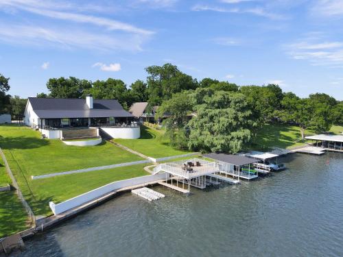 an aerial view of a house on the water at River Oaks Luxury Lakeshore Concierge Services Available in Kingsland