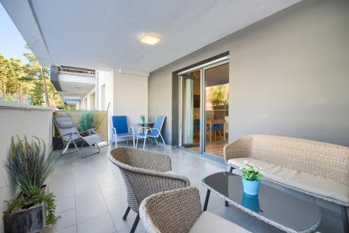 a living room with chairs and a couch and a table at Studio 44 Baltic Park, 280m do Plaży, Duży balkon in Pogorzelica