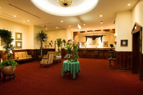 a room with a table with flowers on it at Dukes Hotel Hakata in Fukuoka