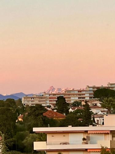 a building with a pink sky in the background at Luxury Penthouse near the Beach in Antibes