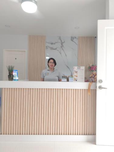 a woman standing behind a counter in a room at Tropical Stay Accommodations Dao in Tagbilaran City