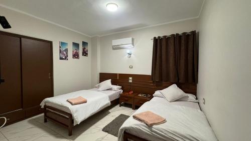 a hotel room with two beds and a window at Royal hotel Tanta - فندق رويال طنطا in Tanta