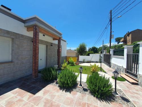 a brick house with a courtyard with plants at Villa Lloret de Mar 6 Personas in Vidreres