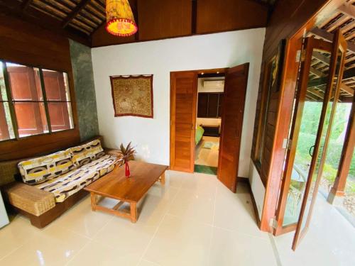 a living room with a couch and a table at soi one house in Pai