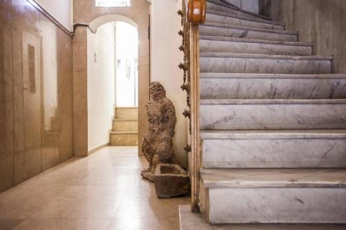 a statue in a hallway with stairs in a building at Exclusive New Modern Apartment at Syntagma Square in Athens