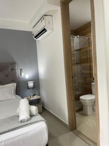 a bedroom with a bed and a shower and a toilet at 110 Loft in Cali