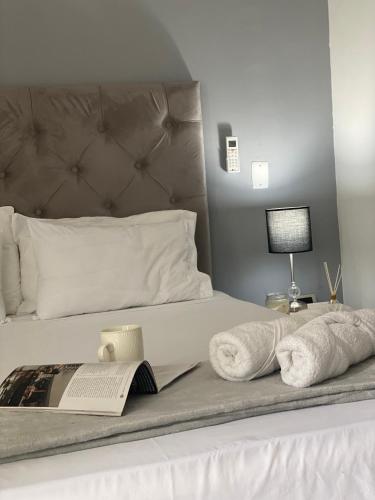 a bedroom with a bed with towels and a book at 110 Loft in Cali