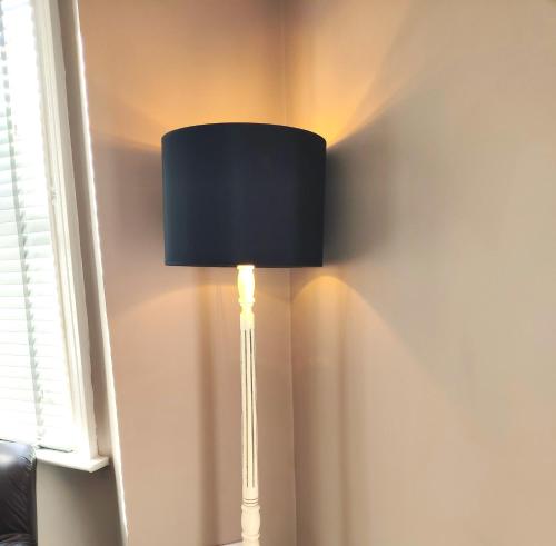 a lamp in the corner of a room at Number 9 in Hunstanton
