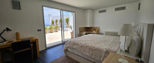 a bedroom with a bed and a view of the ocean at Villa Hafa in Tangier
