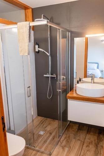 a bathroom with a shower and a sink at CASAS DA MORGADINHA - Casas de Férias e Turismo Rural in Celorico de Basto