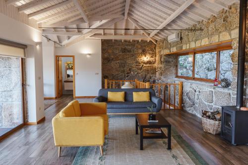 a living room with a couch and a table at CASAS DA MORGADINHA - Casas de Férias e Turismo Rural in Celorico de Basto