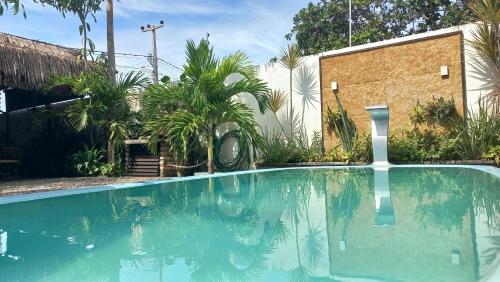 a swimming pool in front of a house at AYRE GOSTOSO POUSADA in São Miguel do Gostoso