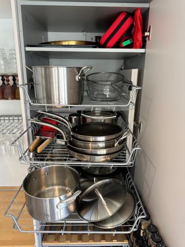 a bunch of pots and pans in a refrigerator at Private 250sqm Garden Duplex, Jacuzzi, Cinema, Sea View Escape in Torremolinos