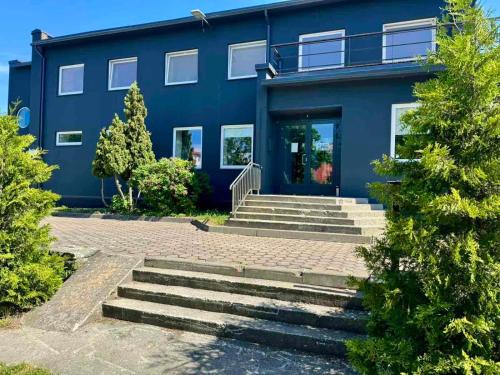 a blue house with stairs in front of it at Paldiski Hotel in Paldiski