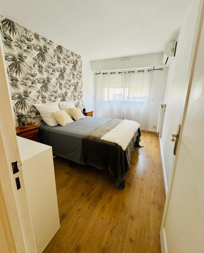 une chambre avec un lit et un mur dans l'établissement T2 appartement Golfe Juan 47m2 plages et port, à Vallauris