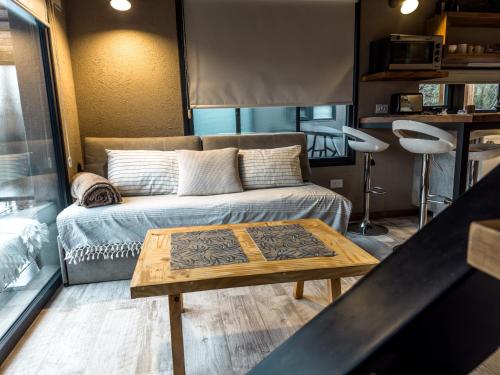 a living room with a couch and a coffee table at Apartamento simple y cómodo in Villa La Angostura