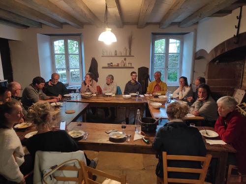 a group of people sitting around a table at Le Pontel in Campuac